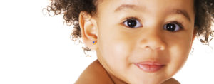 close up of black baby with earrings